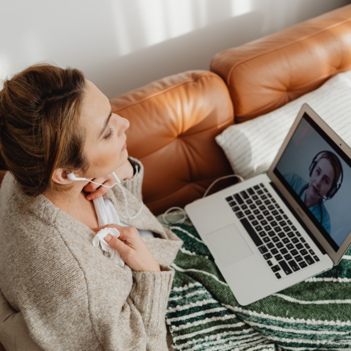 Woman receiving trauma-informed TBI therapy through a secure HIPPA telehealth service.
